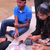 Swati teaching youth to make flowers from plastic spoons